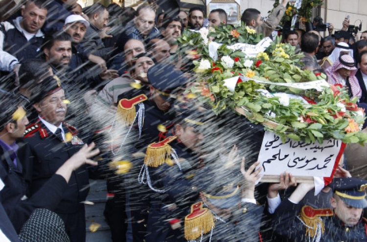 Syria buries bomb victims, threatens ‘iron fist’