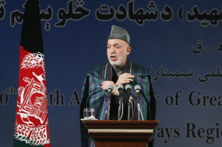 Karzai condemns video of urination on corpses