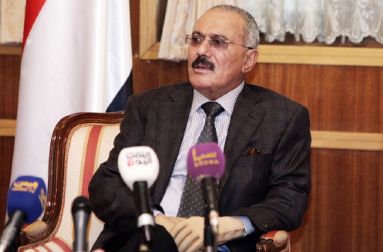 Saleh out, Yemenis remain cautious