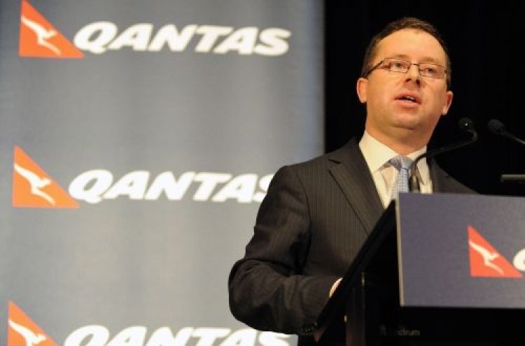 Qantas to slash jobs, cut costs as first-half profit slumps