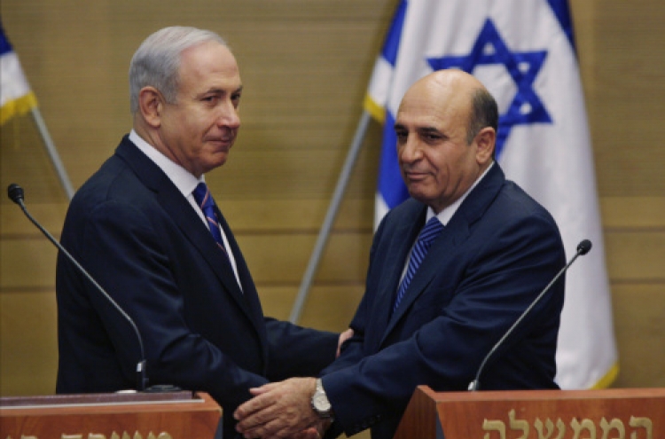 Israel P.M. unveils shock coalition deal with Kadima