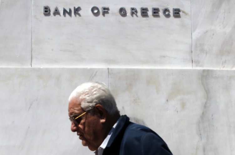 Fitch downgrades Greece, cites euro exit risk