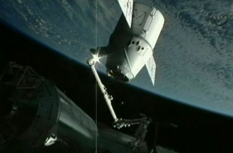 Dragon capsule docks at space station