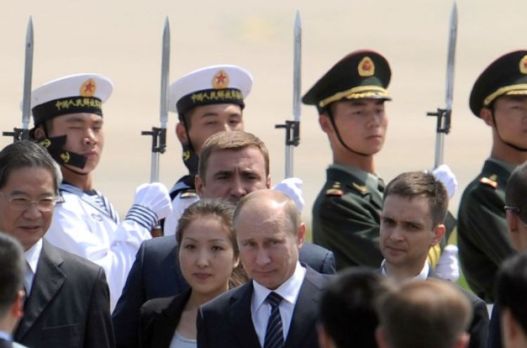 Putin in China to cement ties amid unity on Syria