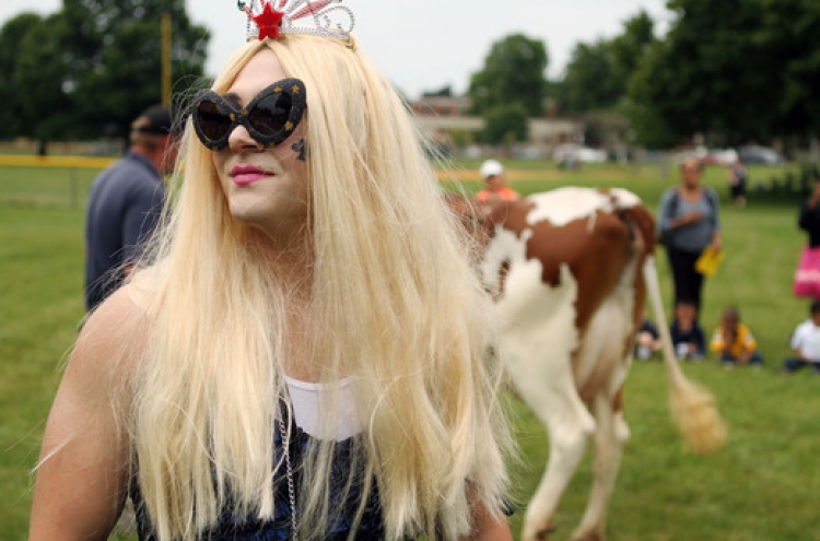 Principal dresses as Lady Gaga, milks cow for bet