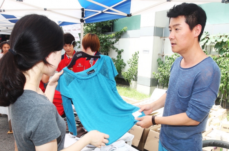 Singer Lee Hyun-woo helps out at bazaar in aid of sick children