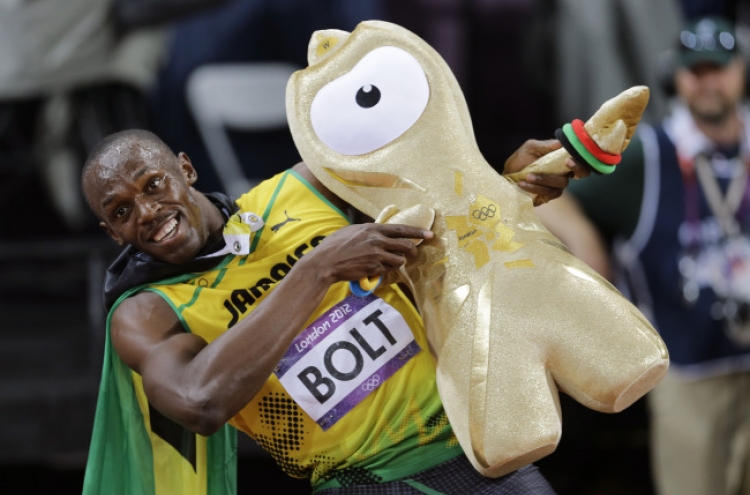 Bolt defends his Olympic 100 title in London