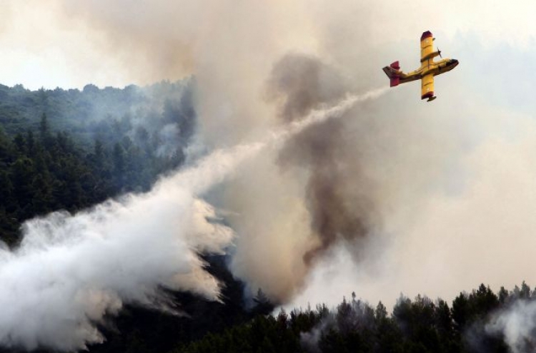 Wildfires rage near Spanish, Greek world heritage sites