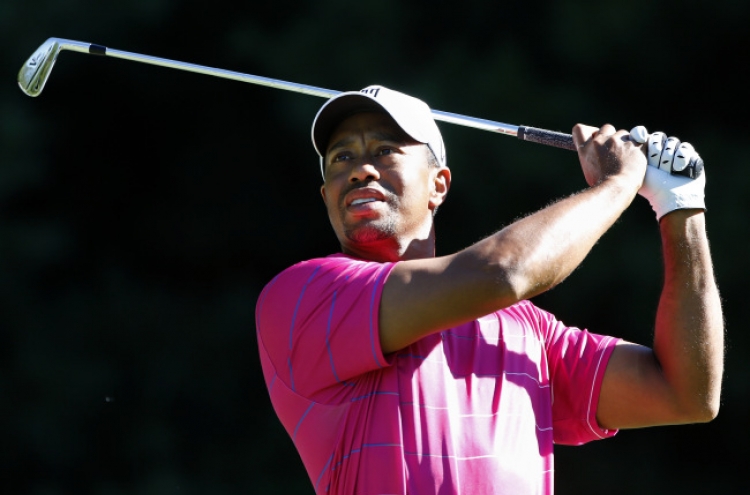 Woods tops $100 million in earnings