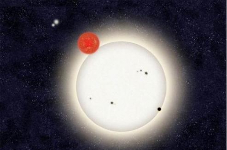 Distant planet found circling with 4 stars