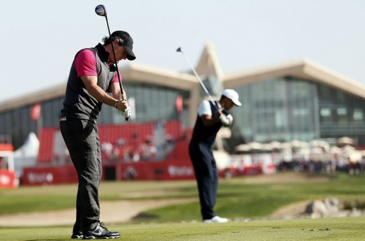 McIlroy, Woods struggle in Abu Dhabi