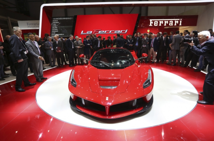 Ferrari, McLaren unveil hybrid supercars