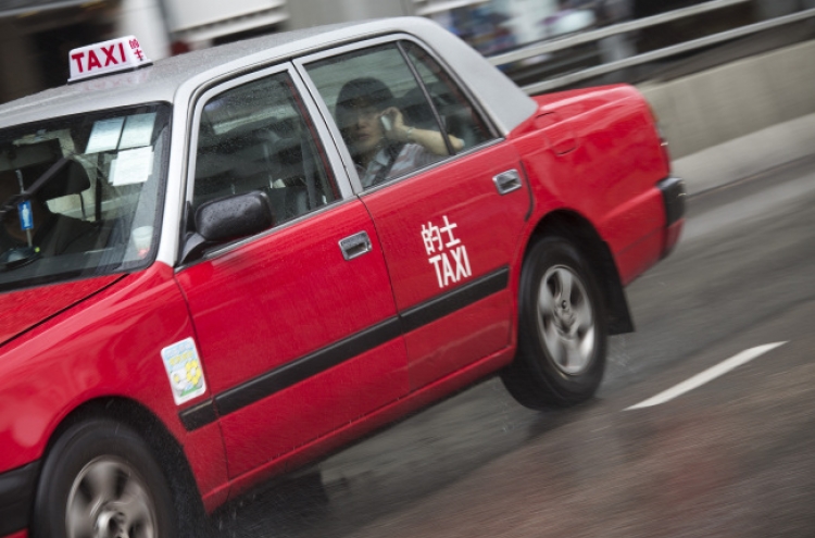 Investors turn H.K.’s red taxis into latest bubble market