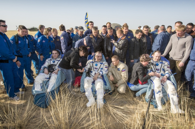 Astronauts back from space station