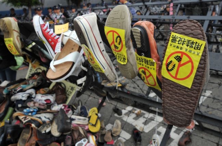 Protesters hurl shoes as Taiwan's ruling party meets