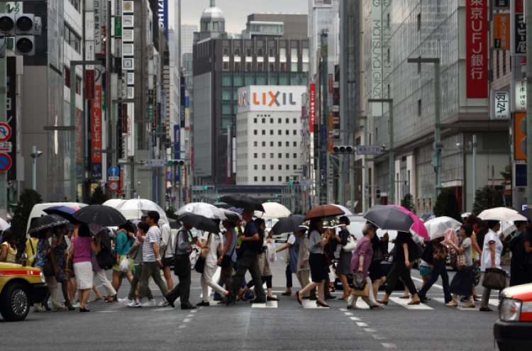 Japan’s economy shrinks on tax hike