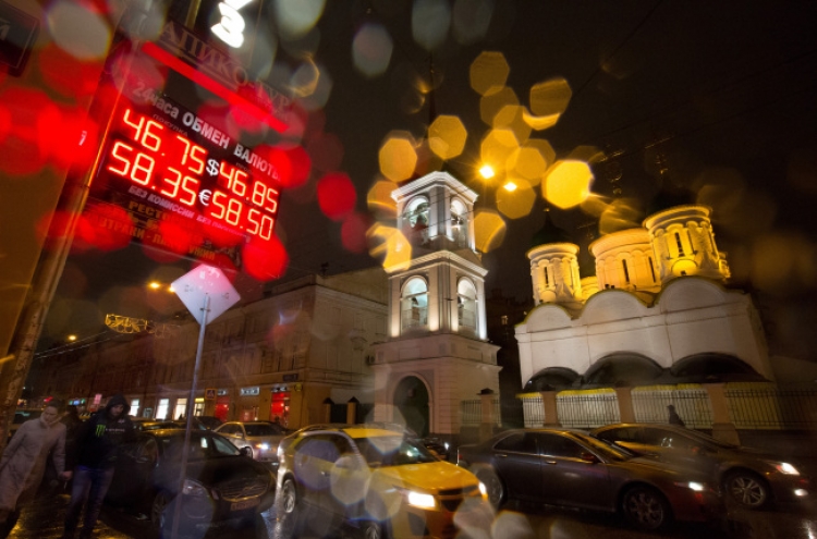 Ruble rebounds from brink but Russians wary