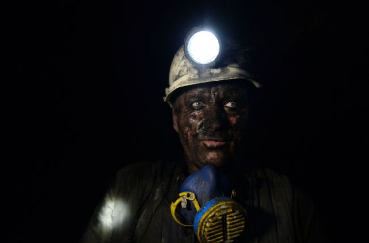 Deep under rebel-held east Ukraine, miners work on