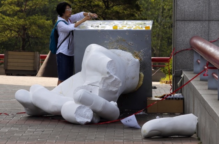 Three booked for destroying controversial sculpture