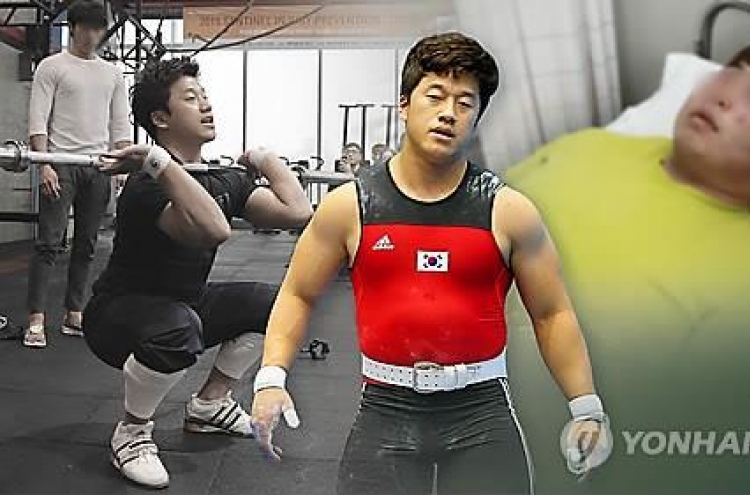 Olympic weightlifting champ ordered to pay fines for assault charges