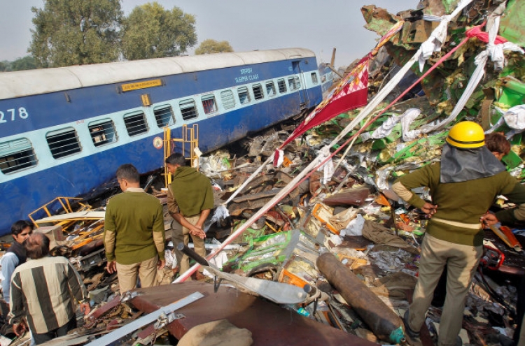 Train derails in north India, killing 104; many trapped