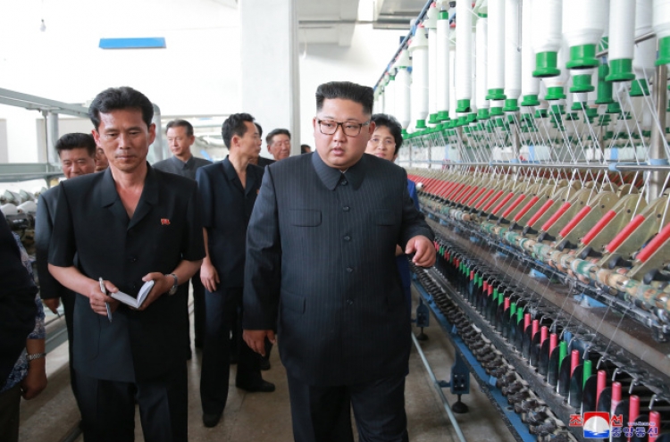 NK leader Kim visits textile plants, chastens workers for not working hard