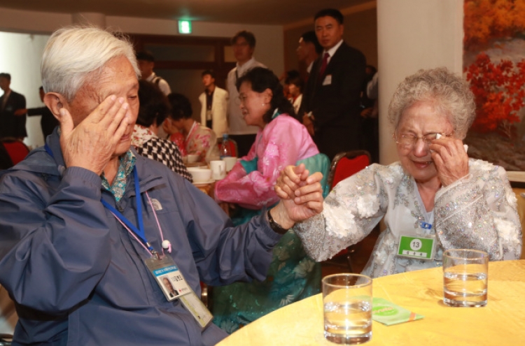 Separated families hold each other one last time