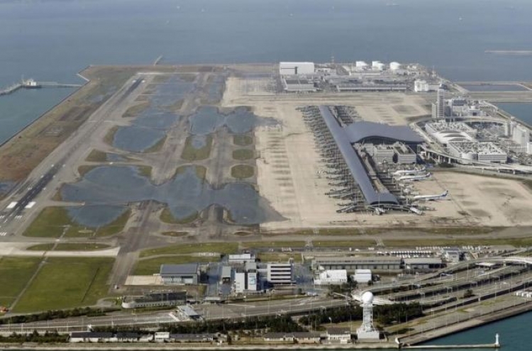 Stranded people leave flooded airport after typhoon in Japan