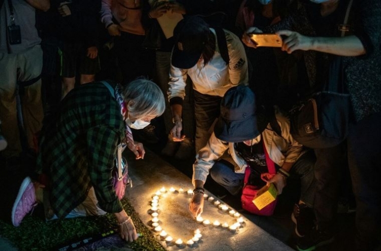 Huge Hong Kong rally after student dies and lawmakers arrested