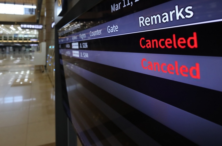 Airlines halt more flights as coronavirus spreads