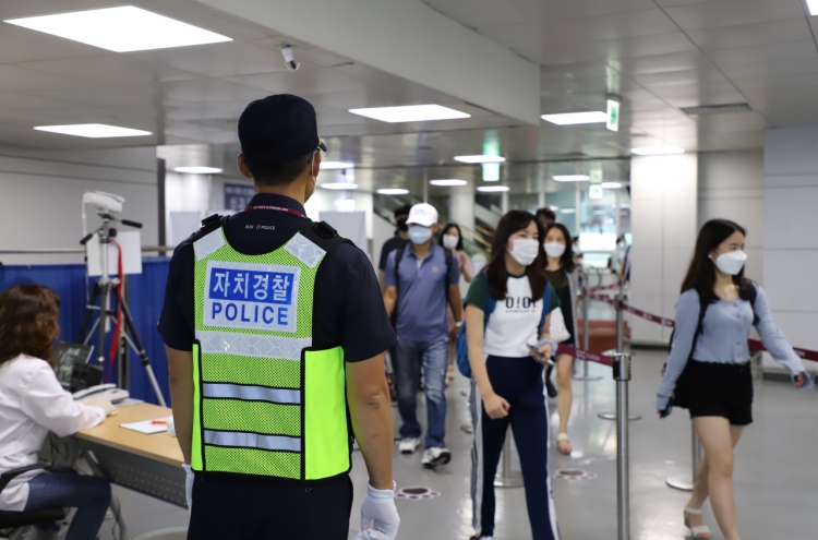 Police patrolling Jeju Airport to fight COVID-19 as more tourists visit the island