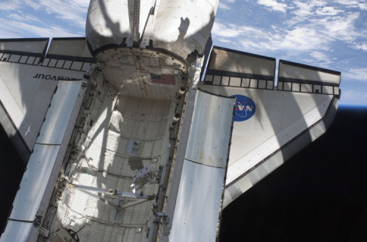 Unprecedented photo op for shuttle-space station