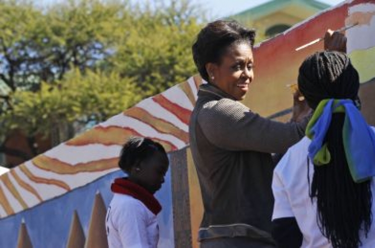 Michelle Obama helps paint mural at clinic in Botswana