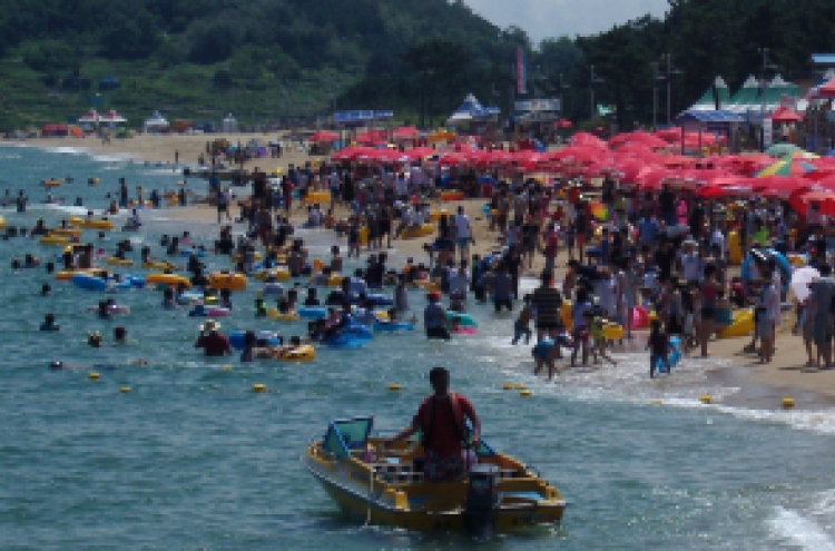 Vacationers swim, sunbathe at provincial beach