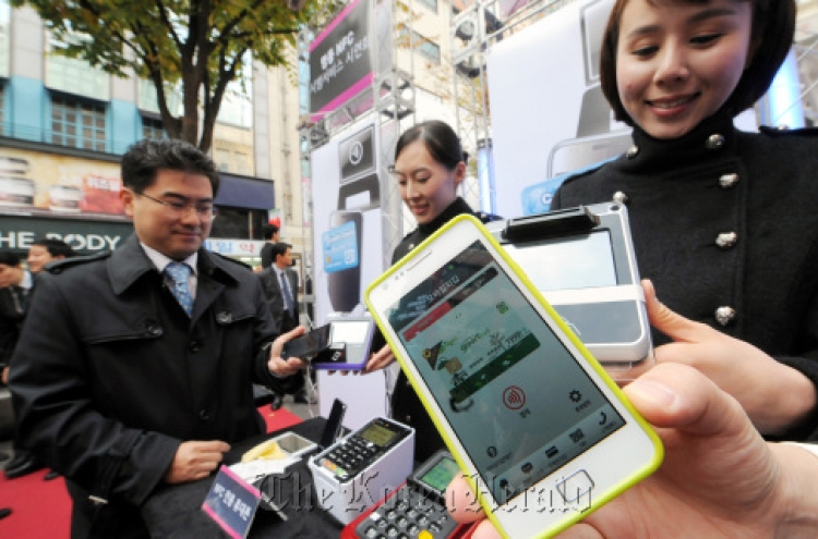 In Myeong-dong, mobile phones replace credit cards