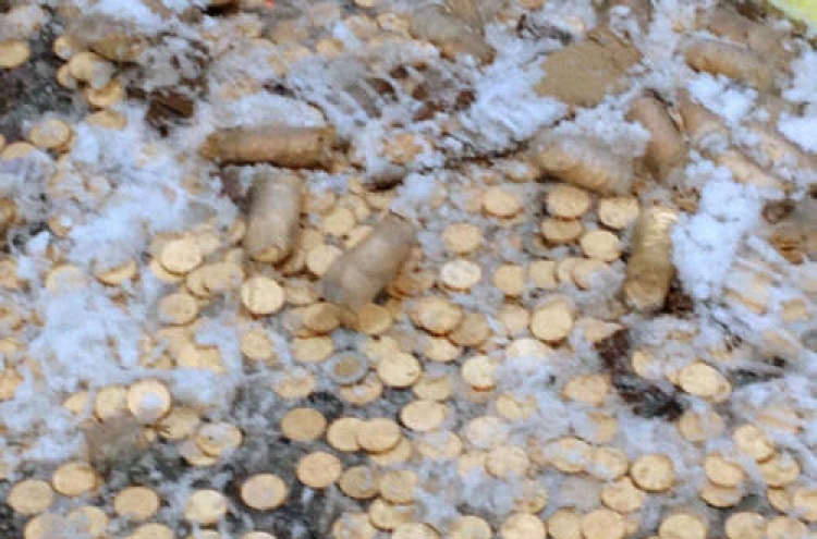 Millions of coins spill on Canada road