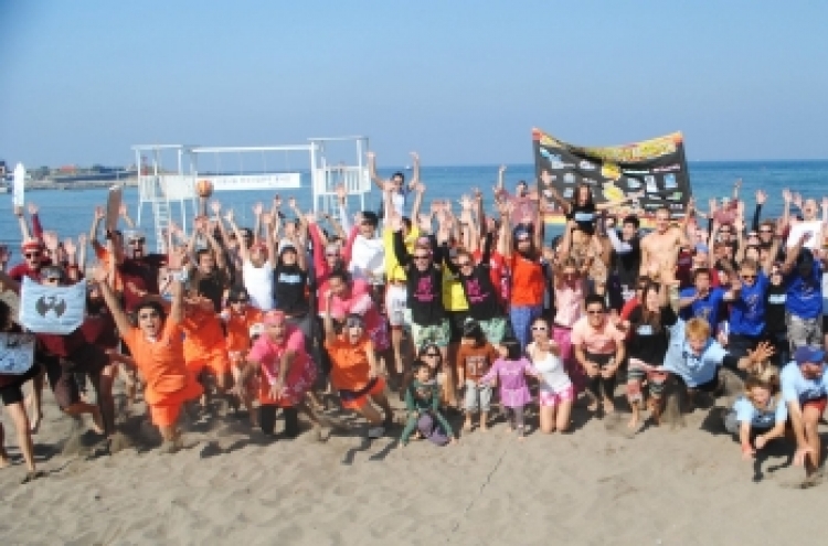 Charity volleyball tourney on Jeju beach
