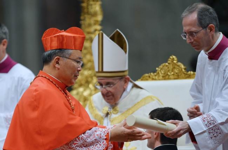 Pope names new cardinals as predecessor looks on