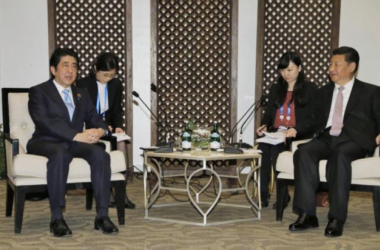 China's Xi, Japan's Abe hold bilateral meeting in Jakarta