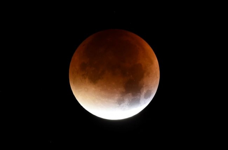 'Super blood moon' shines bright across the world