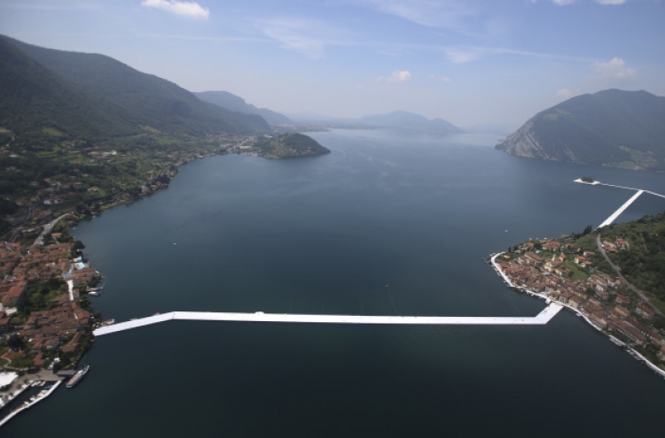 Artist Christo walks on water with “Floating Piers”