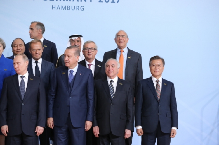 Why was Moon standing in the far corner in G-20 summit photo?