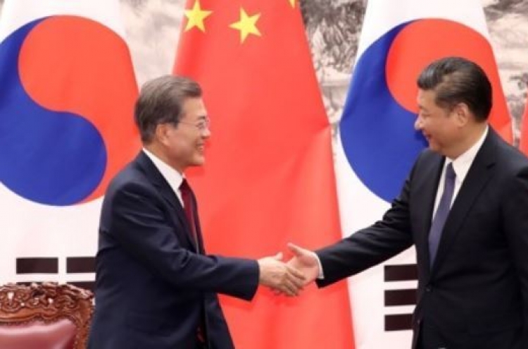 Moon returns home after summit with China's Xi over N. Korea, bilateral ties