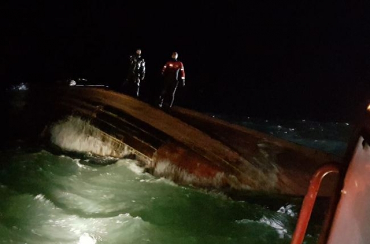 Three found dead in capsized fishing boat