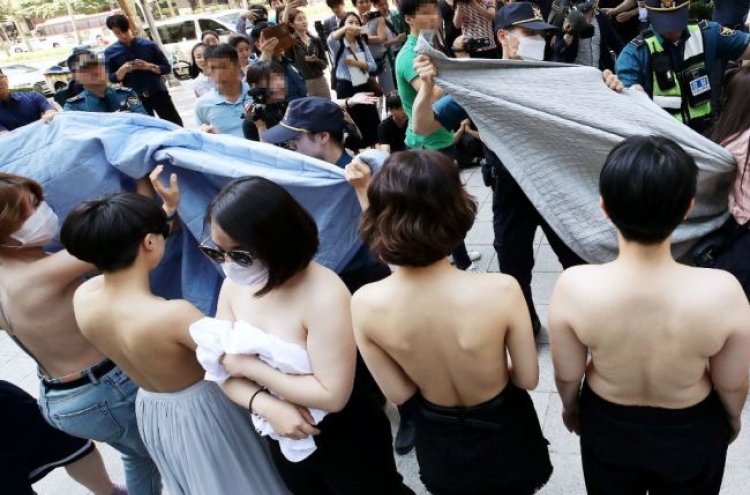 Feminist activists protest topless, Facebook Korea apologizes
