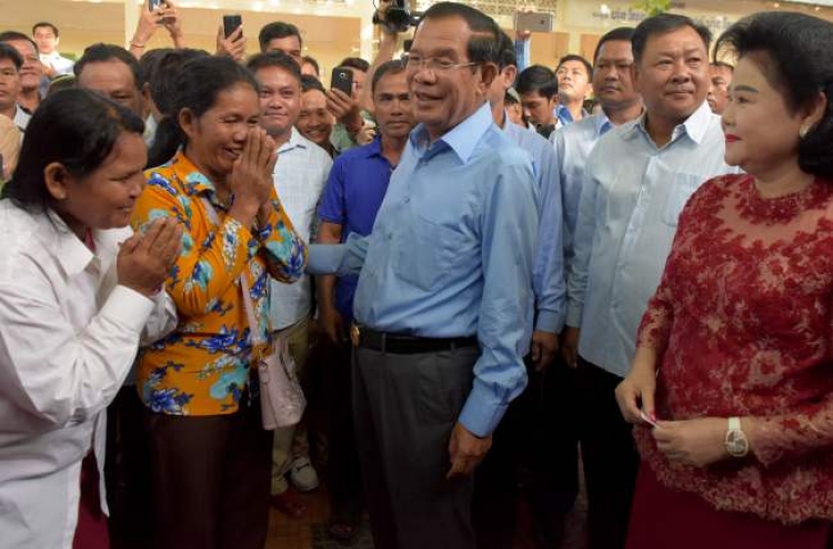 Cambodia ruling party claims 'huge victory' in vote decried as 'sham'