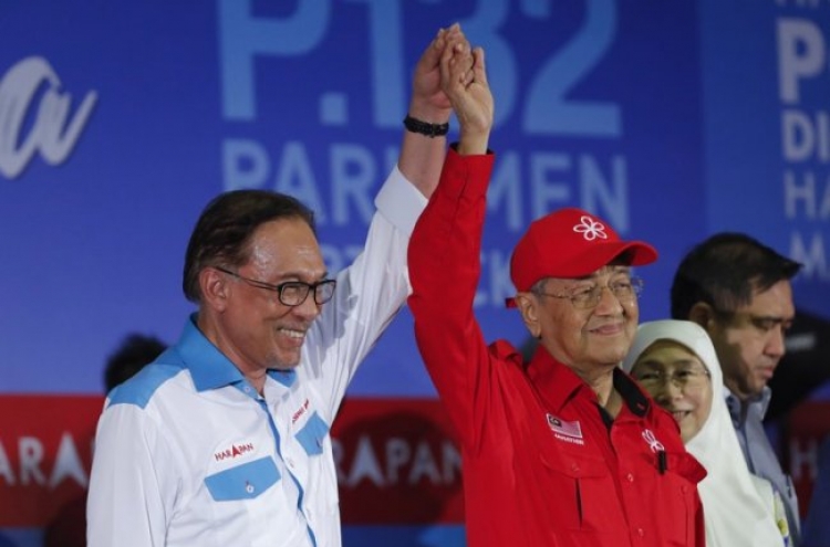 Malaysian PM rallies for successor and former foe Anwar