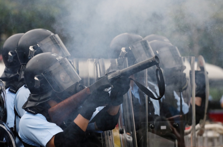 Hong Kong police use tear gas as protesters try to storm parliament