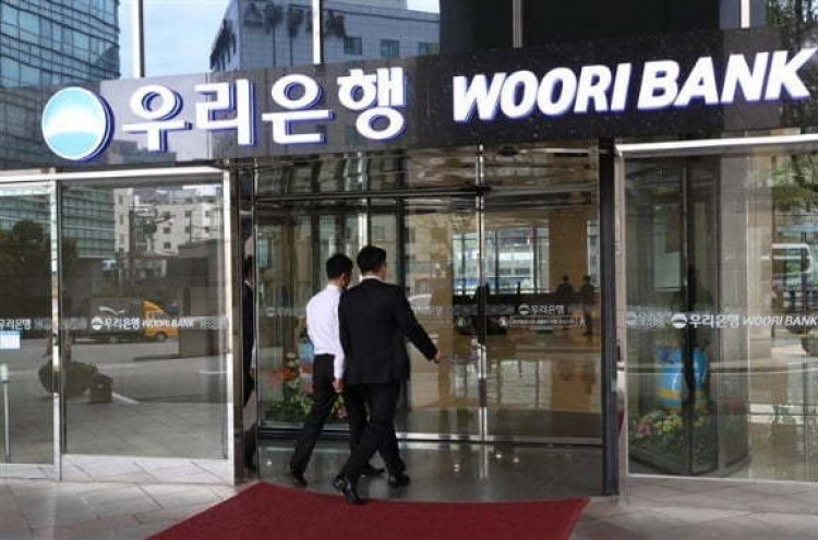 [News Focus] Government offloading Woori stakes to elevate holding company
