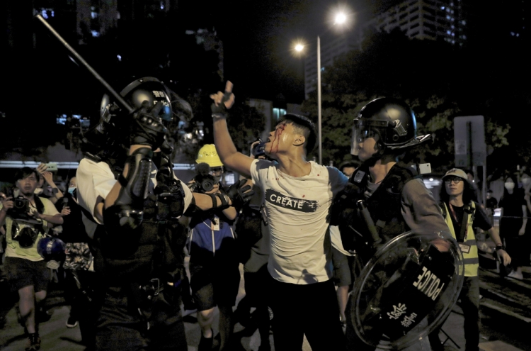 Clashes in Hong Kong after police charge protesters with rioting